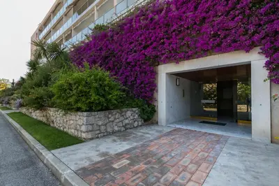 a building with purple flowers on the side of it at FEEL HOME - SAFRANETTE in Villefranche-sur-Mer