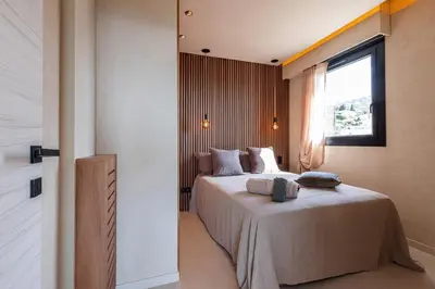 a bedroom with a large bed and a window at FEEL HOME - SAFRANETTE in Villefranche-sur-Mer