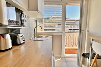 a kitchen with a view of a city from a window at L'Azur Plaisance in Nice