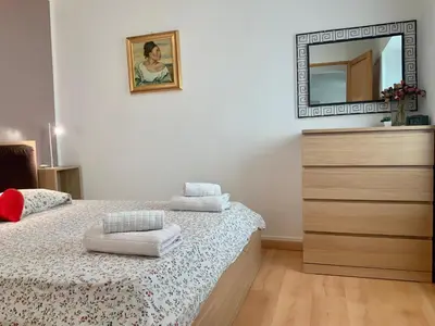 a bedroom with a bed with a dresser and a mirror at Very cosy flat in heart of Old Town of Nice near beach in Nice