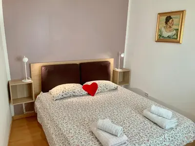 a bedroom with a bed with a red heart on it at Very cosy flat in heart of Old Town of Nice near beach in Nice