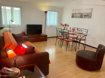 a living room with a couch and a table with chairs at Very cosy flat in heart of Old Town of Nice near beach in Nice