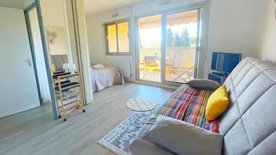 a living room with a couch and a balcony at Eden Beach in Cagnes-sur-Mer