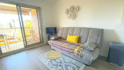 a living room with a couch and a table at Eden Beach in Cagnes-sur-Mer