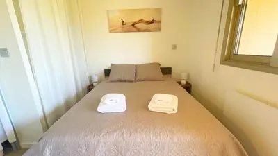 a bedroom with a bed with two towels on it at Eden Beach in Cagnes-sur-Mer