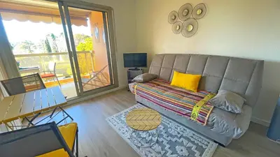 a living room with a couch and a table at Eden Beach in Cagnes-sur-Mer