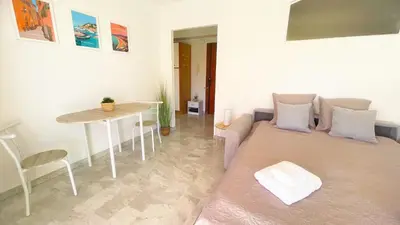 a living room with a couch and a table at La Couronne du Cros in Cagnes-sur-Mer
