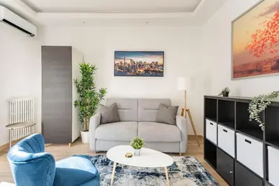 a living room with a couch and a table at Renovated Apartment Near the Beach in Nice