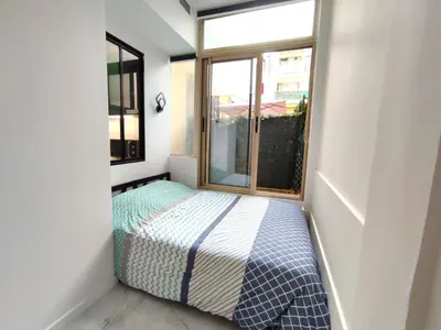a small bedroom with a bed and a window at GARDEN LEVEL nearby beach in Nice