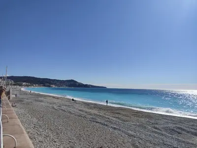 a view of a beach with people in the water at GARDEN LEVEL nearby beach in Nice