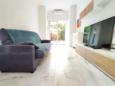 a living room with a couch and a flat screen tv at GARDEN LEVEL nearby beach in Nice