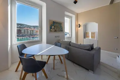 a living room with a table and a couch at Sea view, vue sur la mer Port De Nice - Appartement de charme 2 P in Nice
