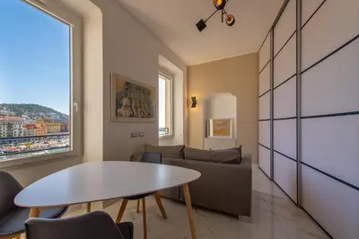 a living room with a table and a couch at Sea view, vue sur la mer Port De Nice - Appartement de charme 2 P in Nice