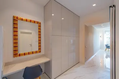 a white bathroom with a mirror and a chair at Sea view, vue sur la mer Port De Nice - Appartement de charme 2 P in Nice