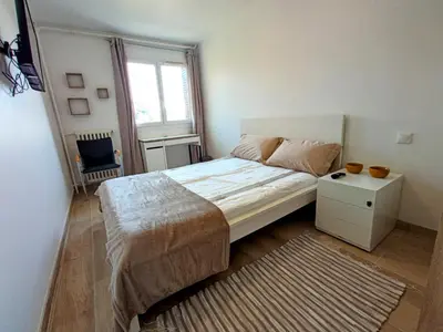 a small bedroom with a bed and a window at Private room in renovated apartment - Tram 1 min walk in Nice