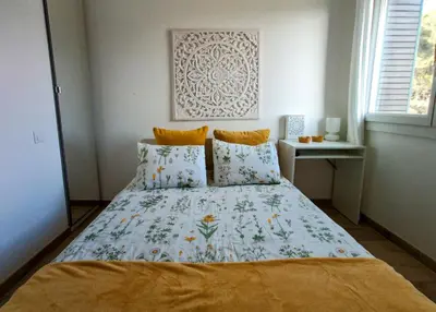 a bedroom with a bed with a floral bedspread at Private room in renovated apartment - Tram 1 min walk in Nice