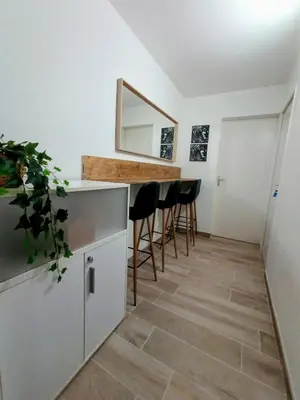 a kitchen with a counter and stools and a mirror at Private room in renovated apartment - Tram 1 min walk in Nice