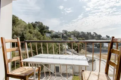 a balcony with a table and chairs and a view at Private room in renovated apartment - Tram 1 min walk in Nice
