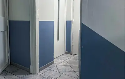 a hallway with blue and white walls and a tile floor at Nice Apartment In Nice With Wifi in Nice