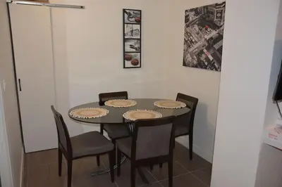 a dining room table with four chairs around it at 4 pièces à Nice - 20 min de la plage in Nice