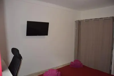 a room with a flat screen tv on the wall at 4 pièces à Nice - 20 min de la plage in Nice