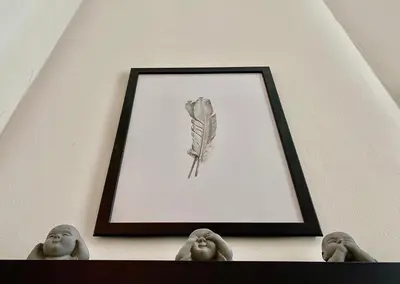 a drawing of a feather hanging on a wall at Lovely & cozy duplex heart of Nice with bathtub! in Nice
