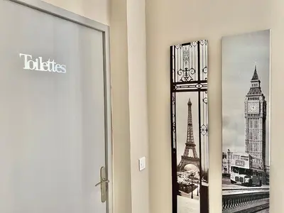 a bathroom door with a picture of the eiffel tower at Lovely & cozy duplex heart of Nice with bathtub! in Nice