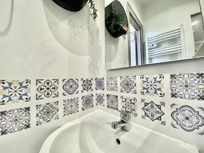 a bathroom with a sink and a mirror and tiles at Lovely & cozy duplex heart of Nice with bathtub! in Nice