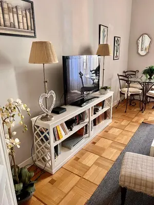 a living room with a white entertainment center with a tv at Magnifique 2 pièces de 65m2 -quartier des Musiciens in Nice