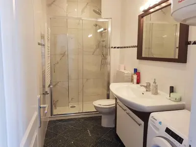 a bathroom with a shower and a toilet and a sink at Nice & Les Cypres in Nice
