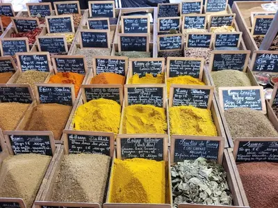 a display of different types of spices in wooden boxes at Nice & Les Cypres in Nice