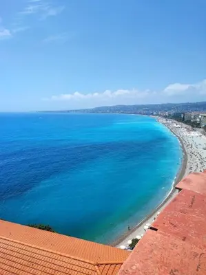 an aerial view of a beach with blue water at Nice & Les Cypres in Nice