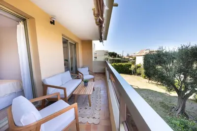 a balcony with white furniture and a view at Lumineux, tout confort, Wifi & Terrace & Parking in Saint-Laurent-du-Var