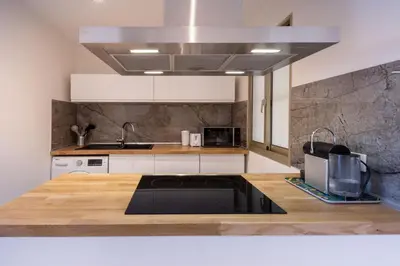 a kitchen with a sink and a stove top oven at Lumineux, tout confort, Wifi & Terrace & Parking in Saint-Laurent-du-Var