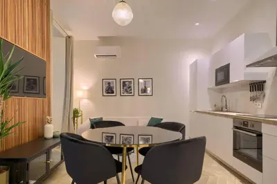 a kitchen and dining room with a table and chairs at CASA ALMA. Hyper Centre. Luxe. in Nice