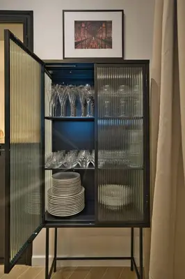 a black cabinet filled with plates and glasses at CASA ALMA. Hyper Centre. Luxe. in Nice