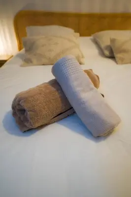 a rolled up towel on top of a bed at CASA ALMA. Hyper Centre. Luxe. in Nice