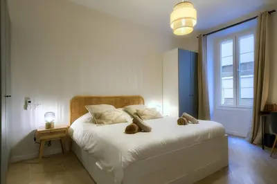 a bedroom with a bed with two teddy bears on it at CASA ALMA. Hyper Centre. Luxe. in Nice