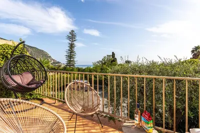 a balcony with two chairs and a fence at VILLA LUNA VI4339 By Riviera Holiday Homes in Èze