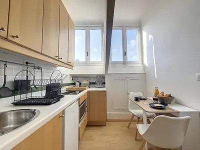 a kitchen with a sink and a table with chairs at Nestor&Jeeves - CITY BREAK - Central - Very close sea in Nice