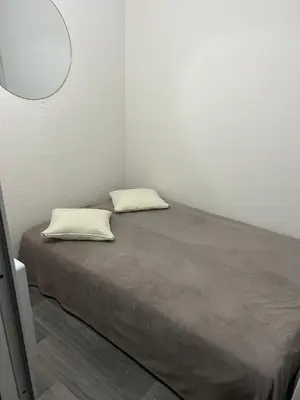 a bed in a room with two pillows on it at Studio Centre Ville in Nice
