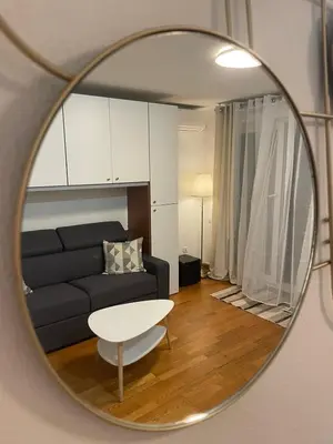 a living room with a couch and a table in a mirror at Studio Centre Ville in Nice