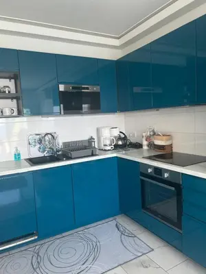 a kitchen with blue cabinets and a sink at Le Grand Bleu in Nice