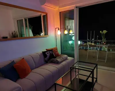 a living room with a couch and a glass table at Nice Promenade des Anglais Vue Mer in Nice