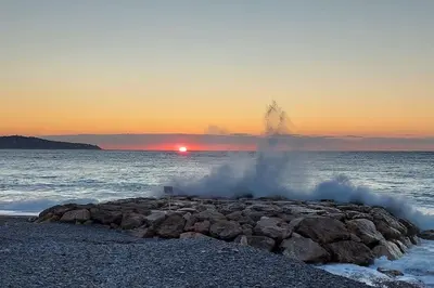 a pile of steam on a rocky beach with the ocean at Nice Promenade des Anglais Vue Mer in Nice