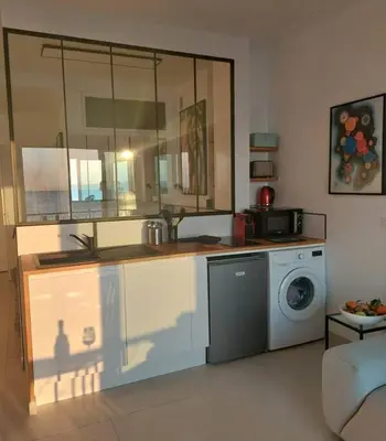 a kitchen with a sink and a washing machine at Nice Promenade des Anglais Vue Mer in Nice
