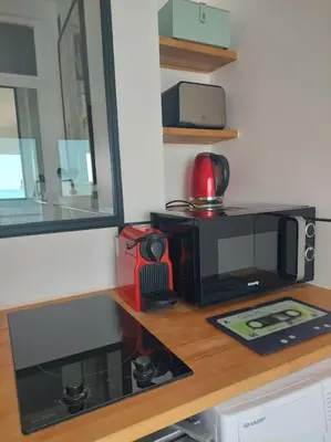 a kitchen counter with a microwave and a coffee maker at Nice Promenade des Anglais Vue Mer in Nice