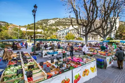 a market in a city with fruits and vegetables on display at Market Square 2 bedrooms 2 baths AC private garage in Beaulieu-sur-Mer