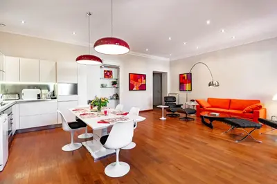 a kitchen and a living room with a table and chairs at Market Square 2 bedrooms 2 baths AC private garage in Beaulieu-sur-Mer