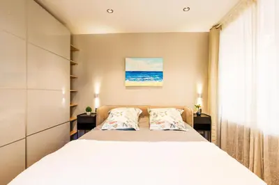 a bedroom with a bed with two pillows at LE MAY AP4338 By Riviera Holiday Homes in Villefranche-sur-Mer